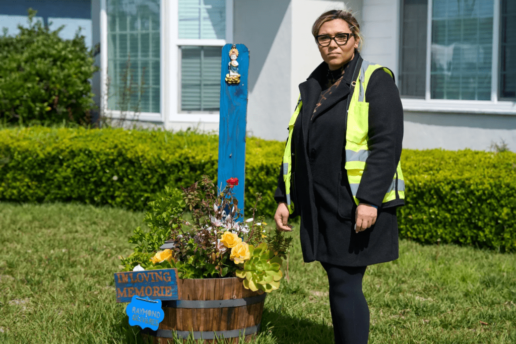 Cindi Enamorado stands beside a memorial for Olivares, her brother, outside his Los Angeles home. Olivares died after being hit by a speeding car while crossing the street to the home he had just bought.